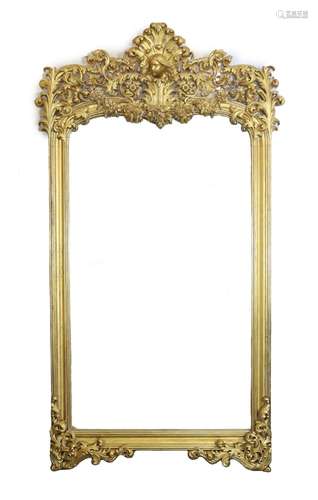 An ornate early 20th century carved giltwood wall mirror, wi...