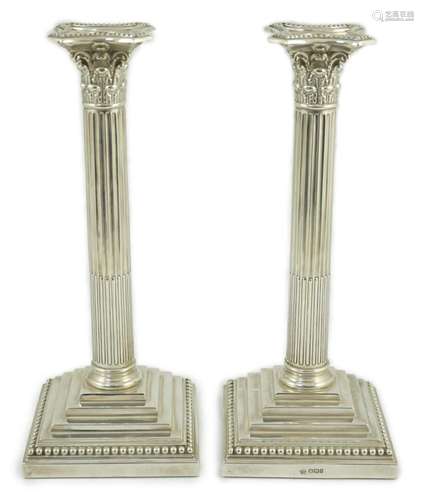 A pair of late Victorian silver Corinthian column candlestic...