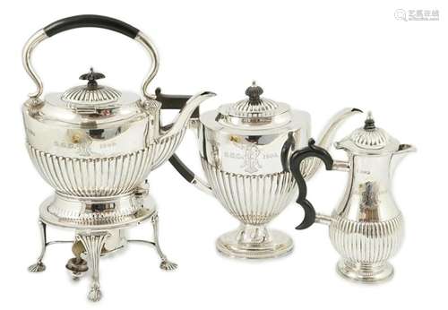 An Edwardian demi-fluted silver tea kettle on stand with bur...