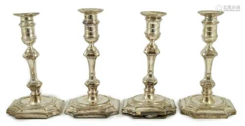 A matched set of four Victorian and later silver candlestick...