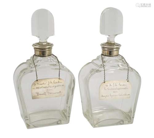 A pair of George VI silver mounted glass decanters and stopp...