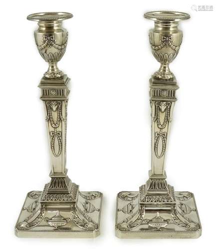 A pair of Elizabeth II Adam style silver candlesticks, by Ba...