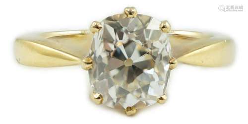 An 18k gold and oval cushion cut solitaire diamond ring