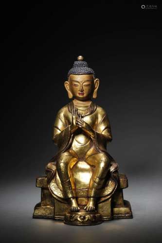 A CHINESE GILT-BRONZE FIGURE OF BUDDA