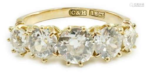 An 18ct gold and graduated five stone diamond set half hoop ...