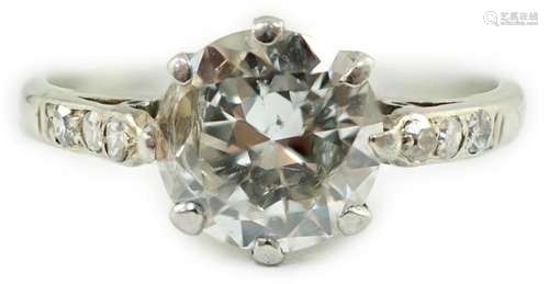 A platinum and single stone diamond ring, with diamond set s...