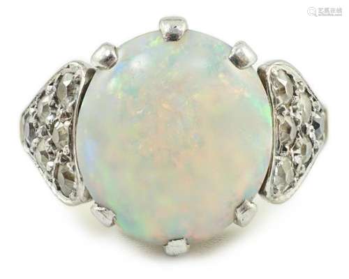 An 18ct gold and single stone white opal set ring, with twel...