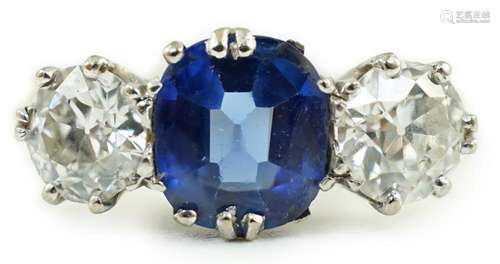 An 18ct gold, single stone oval cut sapphire and two stone r...