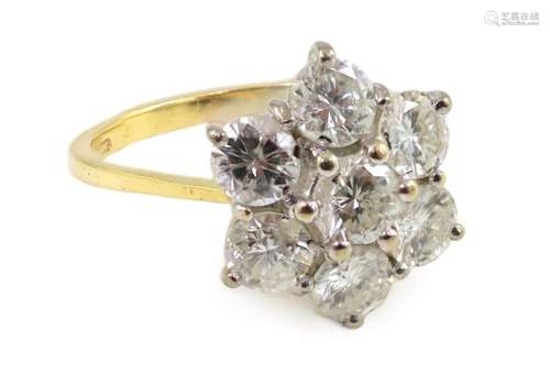 A modern 18ct gold and seven stone diamond set flower head c...