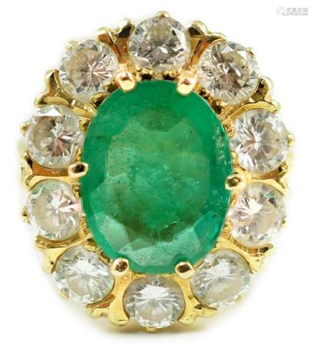 A modern 18ct gold, emerald and diamond set oval cluster rin...