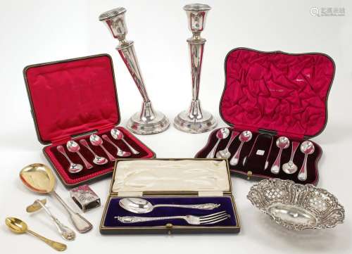 A group of silver, comprising: a pair of silver candlesticks...