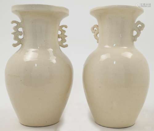 A near pair of cream glazed Chinese style vases, 20th centur...