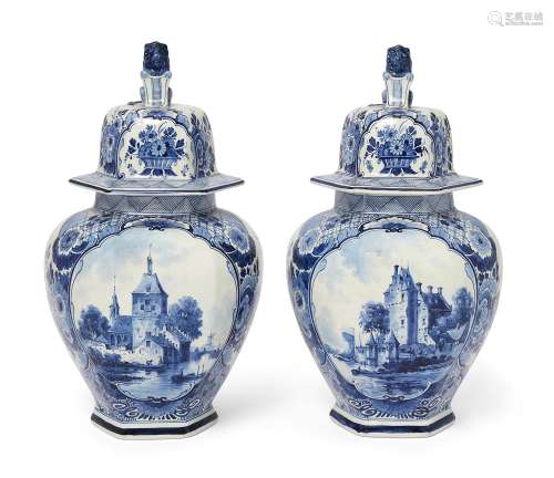 A pair of Dutch Delft blue and white vases and covers, last ...
