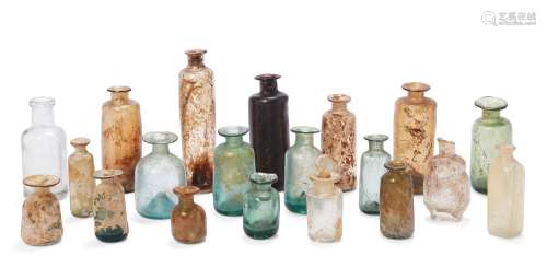 A collection of twenty glass medicine bottles, various dates...