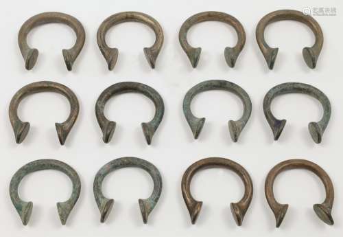 Twelve West African bronze Manilla currency bangles, approx....