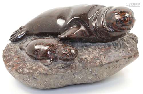 A Cornish Serpentine sculpture of a seal and a pup on a rock...