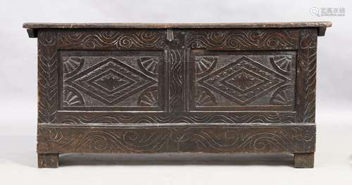 An English oak coffer, 18th century, floral carved, the hing...