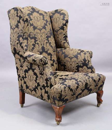 An English mahogany wingback armchair, George III style, las...