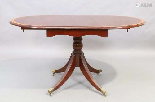 An English mahogany drop leaf dining table, George III style...