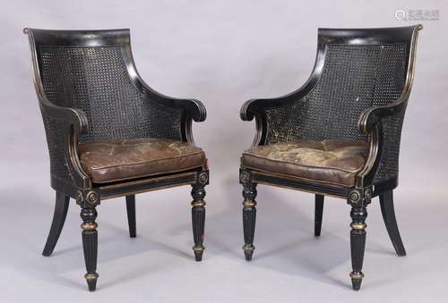 A pair of ebonised caned armchairs, in the Regency style, 20...