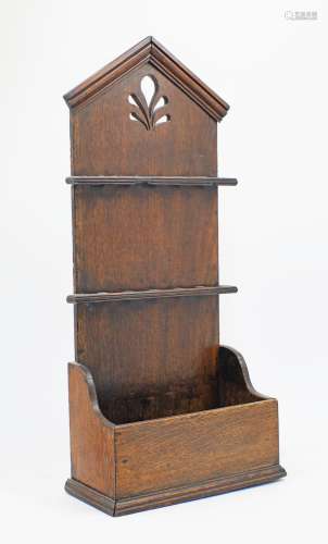 An oak pipe rack, late 19th century, with moulded cornice ab...