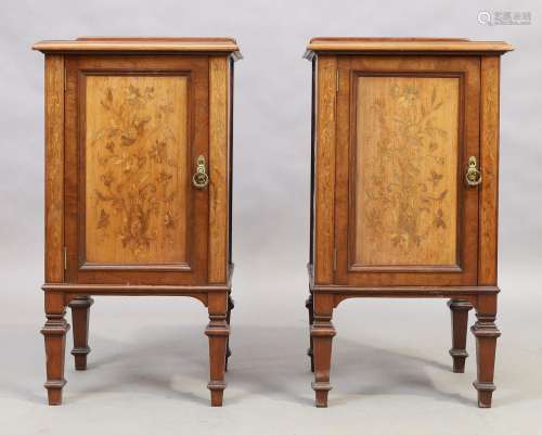 A pair of Edwardian inlaid mahogany bedside cupboards, on sq...