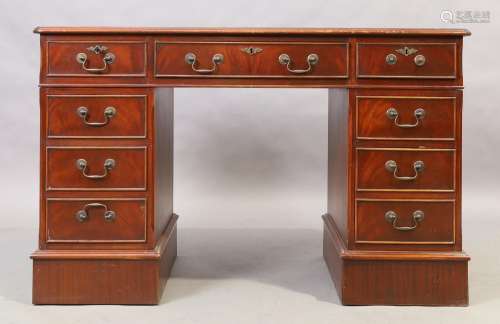 An English mahogany pedestal desk, 20th century, with tooled...