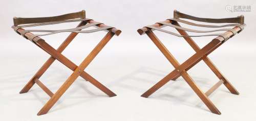 A pair of mahogany folding luggage racks with leather straps...