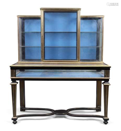 A French brass mounted and parcel gilt ebonised shop display...