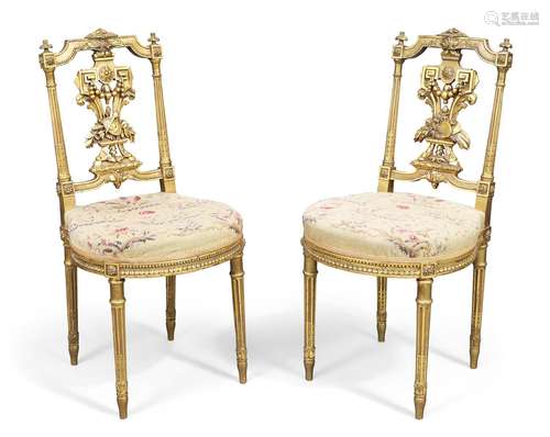 A pair of French giltwood side chairs, Louis XVI style, last...