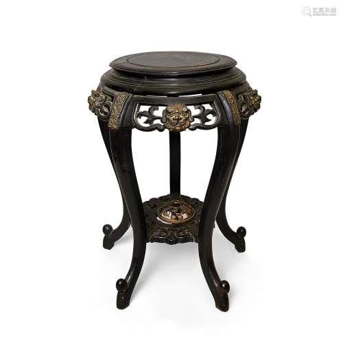 A Chinese hardwood stand, 19th century, with carved wood top...