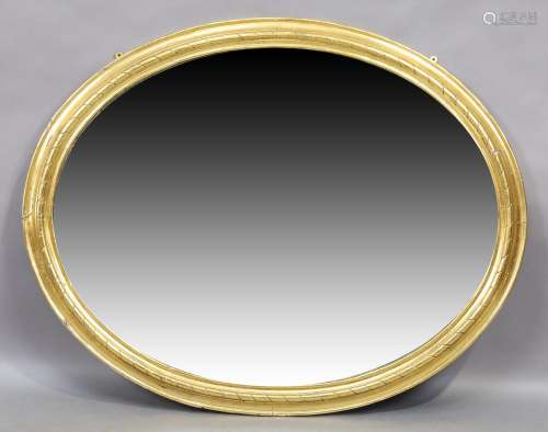 An oval giltwood mirror, first quarter 20th century, with mo...