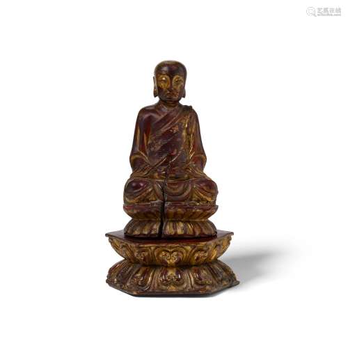 A GILT-LACQUERED WOOD FIGURE OF A SEATED LUOHAN Ming dynasty...