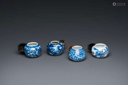 Four Chinese blue, white and copper-red bird feeders, 19th C...