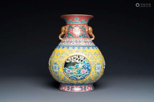 A Chinese reticulated and revolving famille rose vase consis...