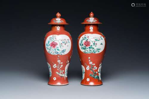 A pair of Chinese famille rose ruby-ground vases and covers,...