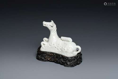 A Chinese white-glazed brush rest in the shape of a resting ...