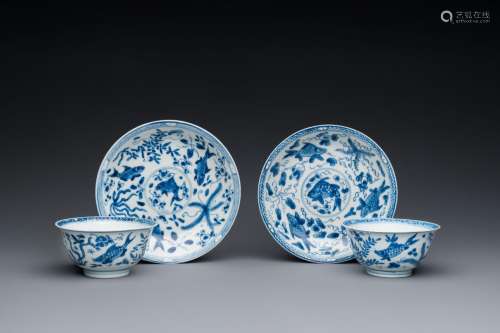 A pair of Chinese blue and white 'carps' cups and saucers, K...