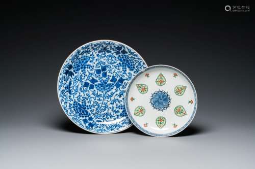 A Chinese blue and white 'peony scroll' dish and a famille v...