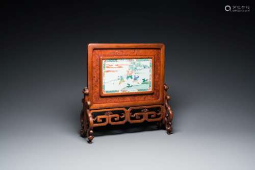 A Chinese famille verte plaque set in a partly huanghuali wo...