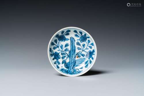 A Chinese blue and white saucer with a pheasant behind a roc...