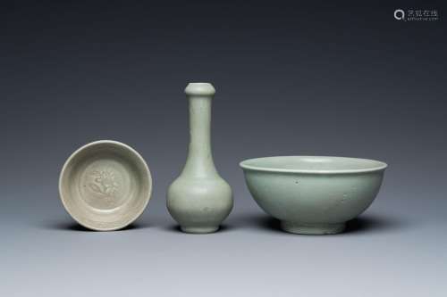 A Chinese celadon-glazed bottle vase and two bowls, Yuan/Min...