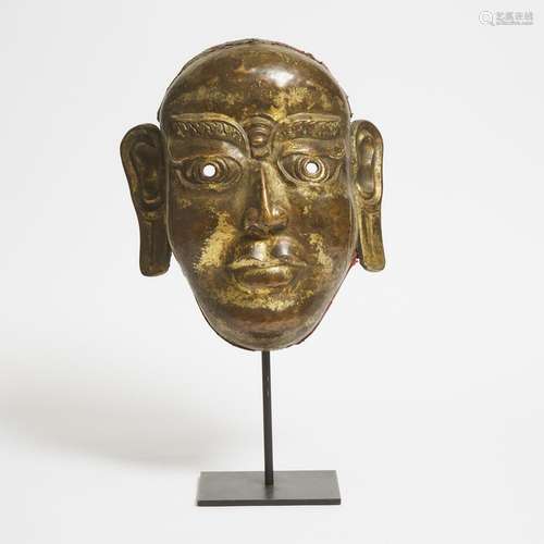 A Large Gilt Bronze Repoussé Mask of a Lama, 18th/19th Centu...