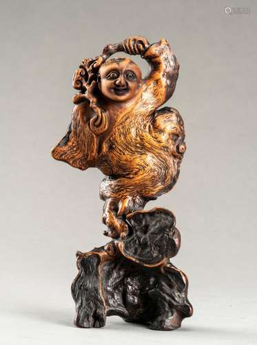 AN EXPRESSIVE ROOT WOOD FIGURE OF A BOY, QING