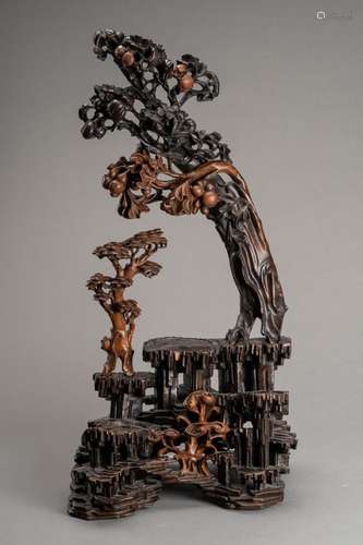 A LARGE CARVED BURLWOOD DISPLAY STAND