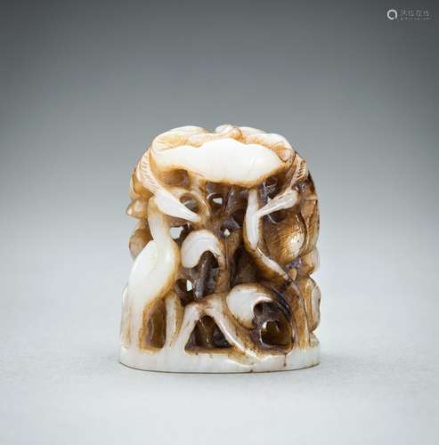 A WHITE AND RUSSET JADE ‘CRANE AND LOTUS’ FINIAL, QING