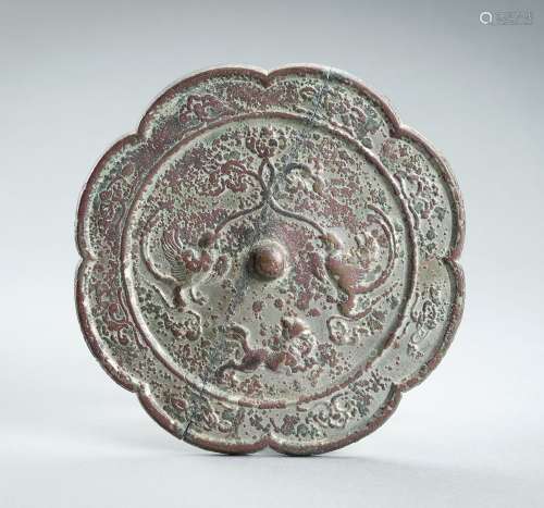 A LARGE EIGHT-LOBED BRONZE ‘PHOENIX AND LION’ MIRROR, TANG