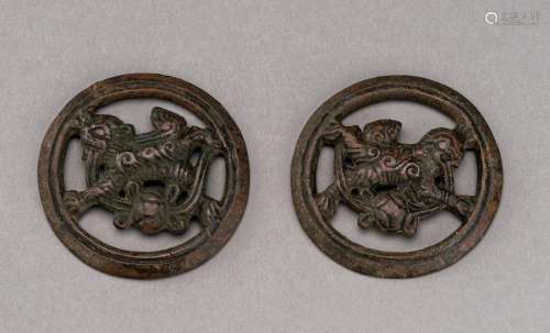 A PAIR OF BRONZE HORSE TRACK ‘BUDDHIST LION’ ORNAMENTS, MING...