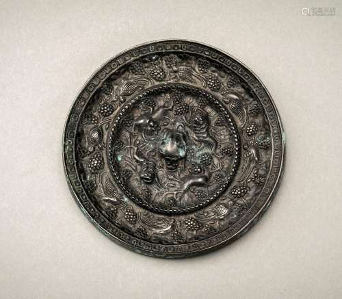 A TANG STYLE BRONZE ‘LION AND GRAPEVINE’ MIRROR