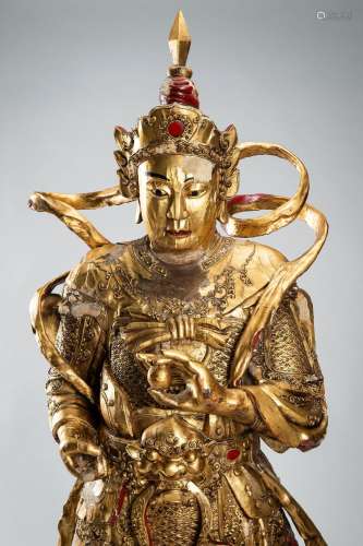 A NEAR LIFE-SIZE GOLD LACQUERED WOOD FIGURE OF A GUARDIAN, Q...